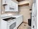 Laundry room with stackable washer and dryer and kitchen appliances at 431 N Harlan St, Lakewood, CO 80226