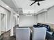 A finished basement area with a black leather couch and two grey chairs at 431 N Harlan St, Lakewood, CO 80226