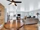 Inviting open-concept living room with hardwood floors, a ceiling fan, and a view of the kitchen at 431 N Harlan St, Lakewood, CO 80226