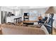 Bright living room featuring an open floorplan with hardwood floors and a modern kitchen with a breakfast bar at 431 N Harlan St, Lakewood, CO 80226