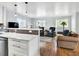 Bright living room with hardwood floors, a cozy seating area, and an open view of the kitchen at 431 N Harlan St, Lakewood, CO 80226