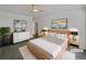 Virtually staged main bedroom with a light wood bed frame at 7770 W 90Th Dr, Broomfield, CO 80021