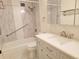 Updated bathroom with tub, shower, gray tile, and modern fixtures at 715 S Alton Way # 10A, Denver, CO 80247
