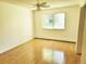 Bright bedroom with hardwood floors, a ceiling fan, and a large window with outdoor views at 715 S Alton Way # 10A, Denver, CO 80247