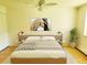 Bright bedroom featuring hardwood floors, ceiling fan, and stylish decor at 715 S Alton Way # 10A, Denver, CO 80247