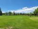 Scenic view of the golf course and manicured lawns under a blue sky at 715 S Alton Way # 10A, Denver, CO 80247