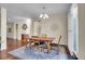 Bright dining area with hardwood floors, chandelier, and access to a deck at 4439 Mcmurdo Ct, Castle Rock, CO 80108