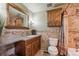 Well-lit bathroom featuring tile backsplash, vanity with cabinets, and a shower with a curtain at 9430 Perry St, Westminster, CO 80031