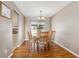 Cozy dining room with hardwood floors, chandelier lighting, and a large window at 9430 Perry St, Westminster, CO 80031