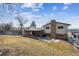 Exterior view of a house with a backyard patio, lawn and a brick chimney at 9430 Perry St, Westminster, CO 80031