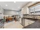 Bright kitchen with white cabinets, granite counters, and stainless steel appliances at 9430 Perry St, Westminster, CO 80031