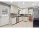 Clean kitchen with white cabinets, modern appliances, and sleek granite countertops at 9430 Perry St, Westminster, CO 80031