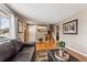 Inviting living area with wood floors, neutral walls, front door, and staircase at 9430 Perry St, Westminster, CO 80031