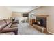 Inviting living room featuring a brick fireplace, plush seating, and a wall-mounted television for cozy evenings at 9430 Perry St, Westminster, CO 80031