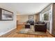 Bright living room features hardwood floors, a comfy sofa, and natural light at 9430 Perry St, Westminster, CO 80031