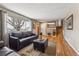 Comfortable living room with hardwood floors, a large window, and a staircase at 9430 Perry St, Westminster, CO 80031