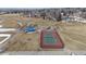 Aerial image of tennis and basketball courts with playground and green space in community at 9430 Perry St, Westminster, CO 80031