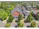 Expansive aerial view showing a red brick home surrounded by mature trees in a neighborhood setting at 11791 Bradburn Blvd, Westminster, CO 80031