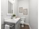 Elegant half bath with a modern vanity, stylish fixtures, and fresh decor and hardwood floors at 11791 Bradburn Blvd, Westminster, CO 80031