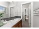 Clean bathroom with marble countertop, wood vanity, and large mirror at 11791 Bradburn Blvd, Westminster, CO 80031
