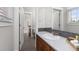 Well-lit bathroom featuring a marble countertop vanity and a view into a connected water closet at 11791 Bradburn Blvd, Westminster, CO 80031