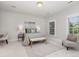 Spacious bedroom with a seating area, large windows, and neutral decor at 11791 Bradburn Blvd, Westminster, CO 80031