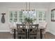 Bright dining room featuring shuttered windows, stylish chandelier, and a gray wood table for comfortable Gathering meals at 11791 Bradburn Blvd, Westminster, CO 80031