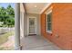 Covered brick front porch with decorative column and secure screen door entry to the home at 11791 Bradburn Blvd, Westminster, CO 80031