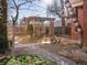 Small backyard with wooden pergola and landscaping at 65 N Logan St # B4, Denver, CO 80203