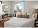 Bedroom with a full-size bed, neutral bedding, and a window at 65 N Logan St # B4, Denver, CO 80203