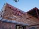 Brick building exterior with a neon sign for Punch Bowl Social at 65 N Logan St # B4, Denver, CO 80203