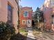 Brick two-story home with a light-colored door and steps at 65 N Logan St # B4, Denver, CO 80203