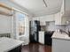Modern kitchen featuring white cabinets, black appliances, and a gray countertop at 65 N Logan St # B4, Denver, CO 80203