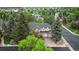 An aerial view of a two-story home, surrounded by mature trees in a neighborhood setting at 16416 E Powers Pl, Centennial, CO 80015