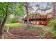 Expansive backyard with tiered landscaping, a deck, and manicured lawn at 16416 E Powers Pl, Centennial, CO 80015