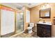 A full bathroom with a tiled walk-in shower and a dark wood vanity with a light countertop at 16416 E Powers Pl, Centennial, CO 80015