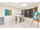 Bright craft room featuring a large work table, lots of storage, natural light, and light wood flooring at 16416 E Powers Pl, Centennial, CO 80015