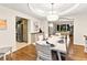 Spacious dining room featuring hardwood floors and an adjacent kitchen at 16416 E Powers Pl, Centennial, CO 80015