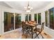 Bright dining area features hardwood floors, a table setting, and backyard view at 16416 E Powers Pl, Centennial, CO 80015