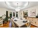 Elegant dining room with a chandelier, table setting, and hardwood floors at 16416 E Powers Pl, Centennial, CO 80015