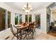 Bright dining area features hardwood floors, a table setting, and backyard view at 16416 E Powers Pl, Centennial, CO 80015
