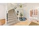 Elegant home entryway with a grand staircase, ceramic tile floors, and beautiful light fixtures at 16416 E Powers Pl, Centennial, CO 80015