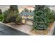 Charming two-story home features a brick facade, lush landscaping, and an attached two-car garage at 16416 E Powers Pl, Centennial, CO 80015