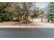 Beautiful home featuring a brick exterior, mature trees, and a two-car garage with brick paver driveway at 16416 E Powers Pl, Centennial, CO 80015