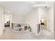 Upstairs hallway featuring white walls, plush carpet and decorative iron railings to the lower floor at 16416 E Powers Pl, Centennial, CO 80015