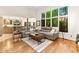 Open floor plan living room with hardwood floors, large window, and neutral decor at 16416 E Powers Pl, Centennial, CO 80015