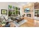 Cozy living room with large window, fireplace, and comfortable seating at 16416 E Powers Pl, Centennial, CO 80015
