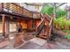 Lower level patio featuring a stone surface and elevated stairs to wooden deck at 16416 E Powers Pl, Centennial, CO 80015