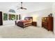 Spacious main bedroom with vaulted ceiling, ceiling fan and large window overlooking the trees at 16416 E Powers Pl, Centennial, CO 80015