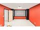 Cozy media room featuring a large screen, plush carpeting, and vibrant red walls at 16416 E Powers Pl, Centennial, CO 80015